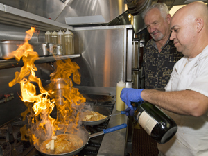 Prew takes pride in his staff, and looks on as the chef expertly prepares a marsala sauce.